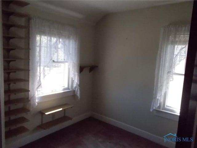 unfurnished room featuring baseboards
