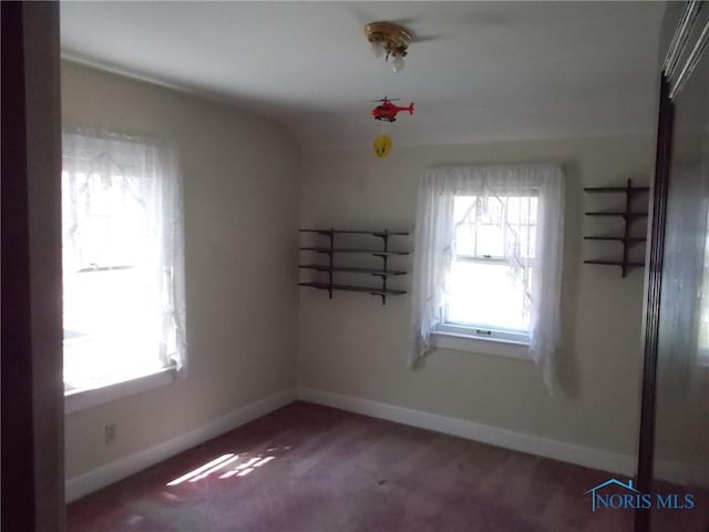 carpeted spare room with baseboards