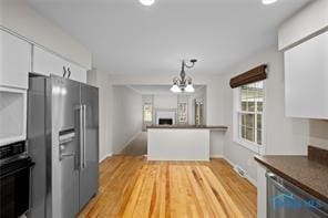kitchen with decorative light fixtures, dark countertops, appliances with stainless steel finishes, white cabinets, and recessed lighting
