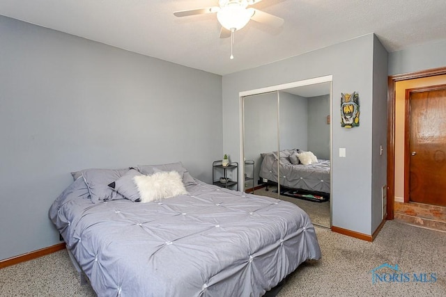 bedroom featuring a closet, a ceiling fan, baseboards, and light colored carpet