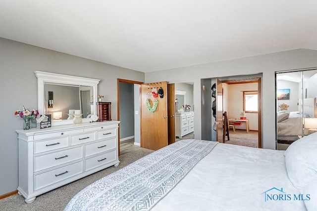 bedroom with baseboards, light carpet, and lofted ceiling