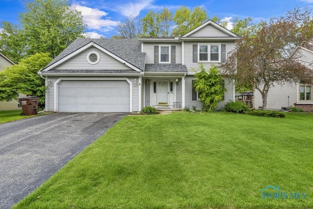 3739 Wild Pheasant Ln, Sylvania, OH 43560 - view of front of home with asphalt driveway, an attached garage, a front yard, and a shingled roof