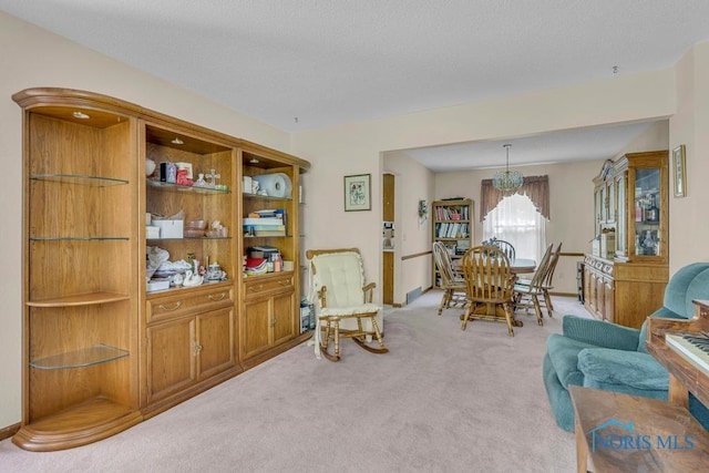 3739 Wild Pheasant Ln, Sylvania, OH 43560 - sitting room with light carpet, a chandelier, and baseboards