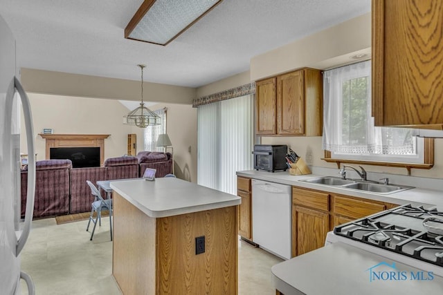 3739 Wild Pheasant Ln, Sylvania, OH 43560 - kitchen featuring a sink, white appliances, a kitchen island, light countertops, and light flooring