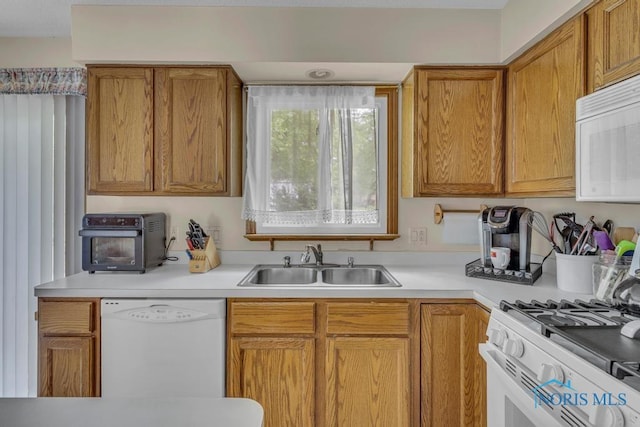 3739 Wild Pheasant Ln, Sylvania, OH 43560 - kitchen with white appliances, a sink, light countertops, and brown cabinets
