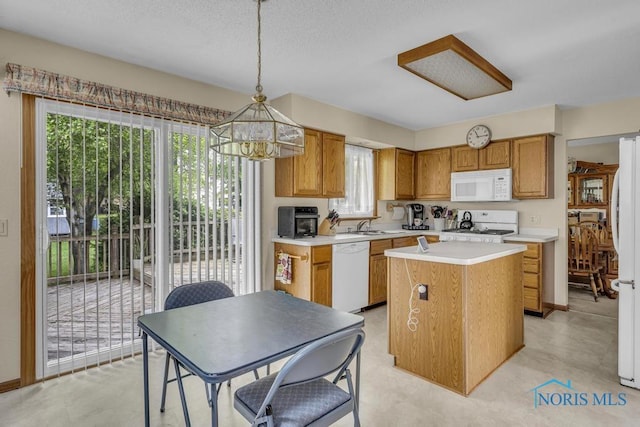 3739 Wild Pheasant Ln, Sylvania, OH 43560 - kitchen with white appliances, light countertops, a center island, a chandelier, and decorative light fixtures