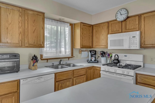 3739 Wild Pheasant Ln, Sylvania, OH 43560 - kitchen with white appliances, a sink, light countertops, and brown cabinetry
