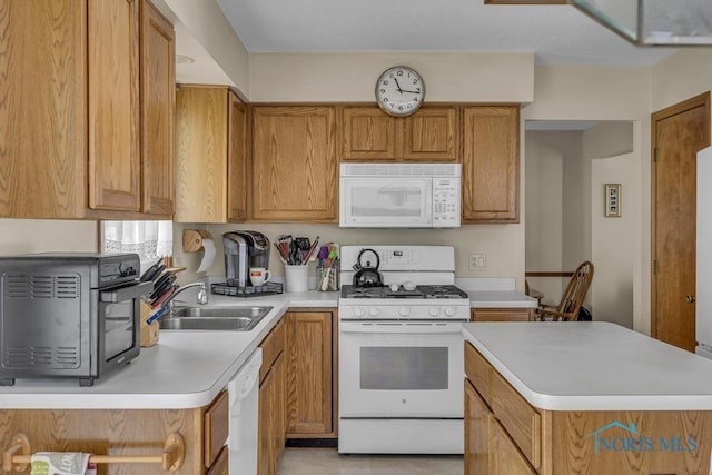 3739 Wild Pheasant Ln, Sylvania, OH 43560 - kitchen featuring white appliances, a sink, light countertops, and brown cabinetry