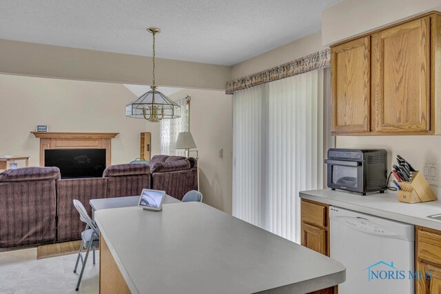 3739 Wild Pheasant Ln, Sylvania, OH 43560 - kitchen featuring dishwasher, a chandelier, light countertops, open floor plan, and pendant lighting