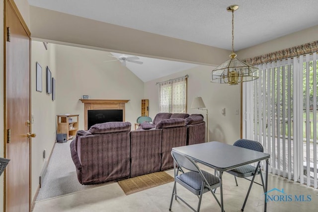 3739 Wild Pheasant Ln, Sylvania, OH 43560 - dining room with plenty of natural light, a ceiling fan, a chandelier, a fireplace, and vaulted ceiling