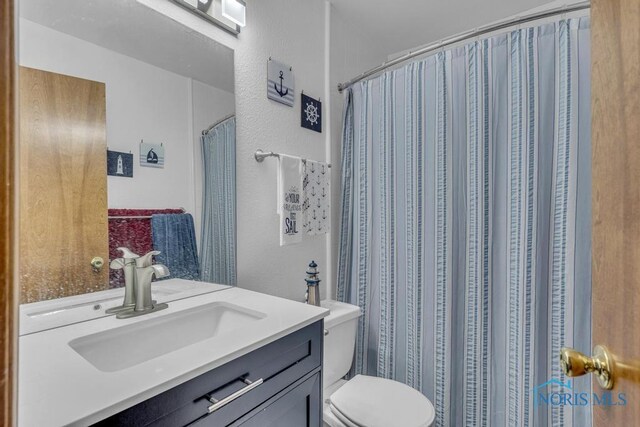 3739 Wild Pheasant Ln, Sylvania, OH 43560 - bathroom with toilet, vanity, and a textured wall
