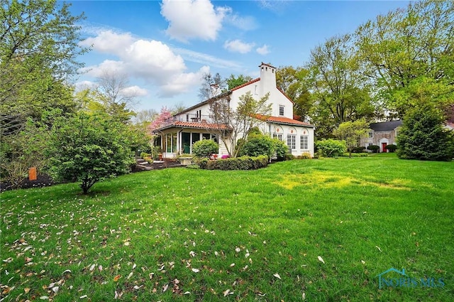 3405 Chestnut Hill Rd, Ottawa Hills, OH 43606 - rear view of house with a yard, a chimney, and a tiled roof