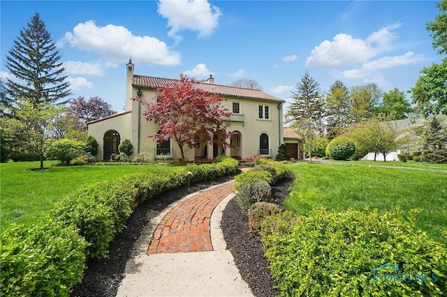 3405 Chestnut Hill Rd, Ottawa Hills, OH 43606 - mediterranean / spanish-style house featuring stucco siding, a chimney, and a front yard