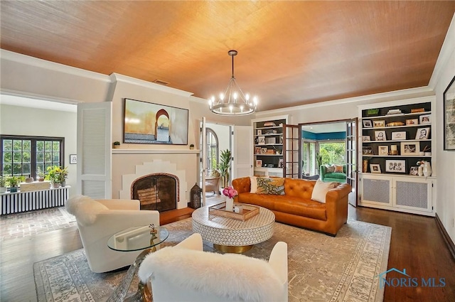 3405 Chestnut Hill Rd, Ottawa Hills, OH 43606 - living room featuring a chandelier, wood finished floors, a fireplace, and ornamental molding