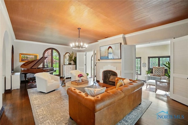 3405 Chestnut Hill Rd, Ottawa Hills, OH 43606 - living room with ornamental molding, a fireplace, arched walkways, wood finished floors, and a chandelier