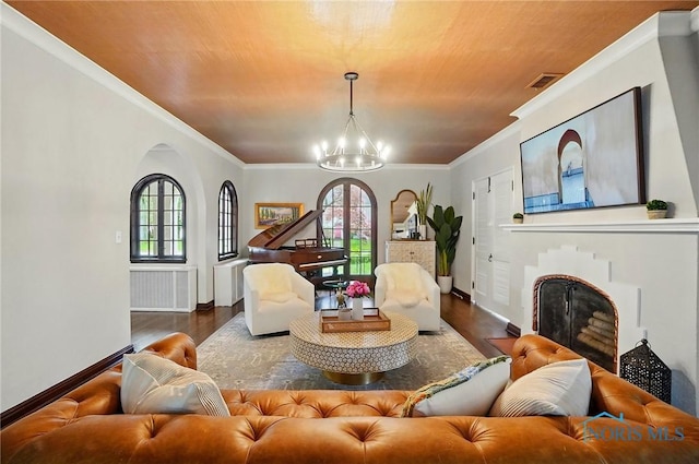 3405 Chestnut Hill Rd, Ottawa Hills, OH 43606 - living area featuring wood finished floors, plenty of natural light, a chandelier, arched walkways, and ornamental molding