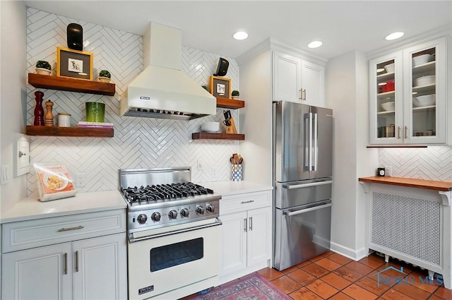 3405 Chestnut Hill Rd, Ottawa Hills, OH 43606 - kitchen featuring freestanding refrigerator, premium stove, ventilation hood, open shelves, and decorative backsplash