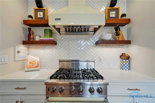 3405 Chestnut Hill Rd, Ottawa Hills, OH 43606 - kitchen featuring under cabinet range hood, open shelves, stainless steel stove, decorative backsplash, and light countertops