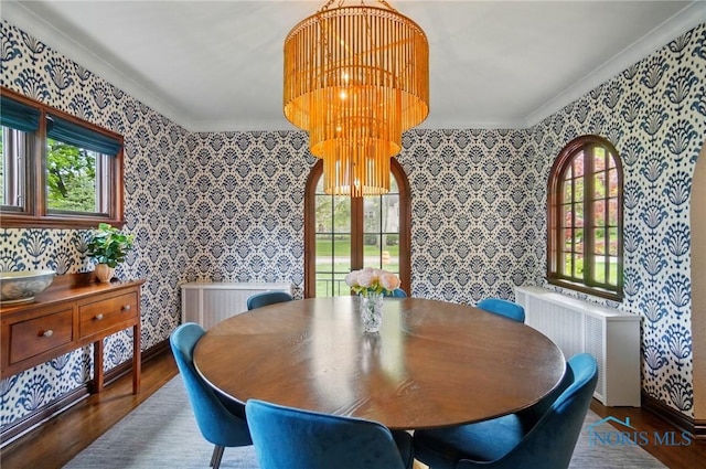 3405 Chestnut Hill Rd, Ottawa Hills, OH 43606 - dining space with wallpapered walls, wood finished floors, plenty of natural light, ornamental molding, and radiator