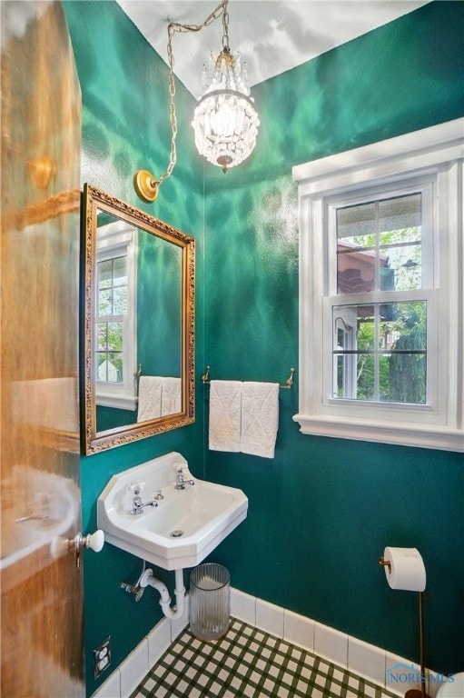 3405 Chestnut Hill Rd, Ottawa Hills, OH 43606 - bathroom featuring plenty of natural light, a chandelier, baseboards, and tile patterned floors