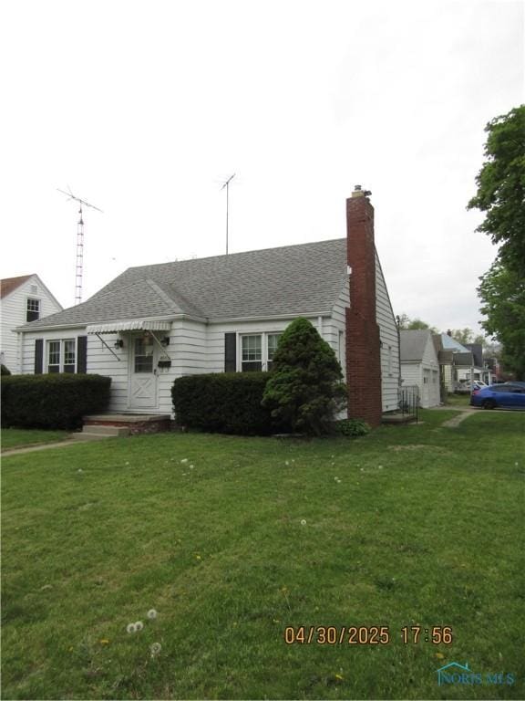 single story home featuring a chimney and a front yard
