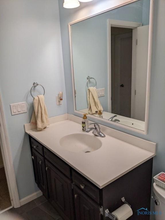 bathroom featuring vanity and toilet
