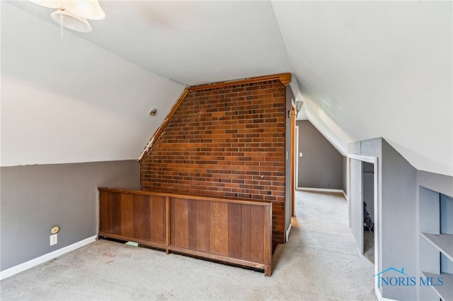 bonus room featuring light colored carpet, baseboards, and lofted ceiling