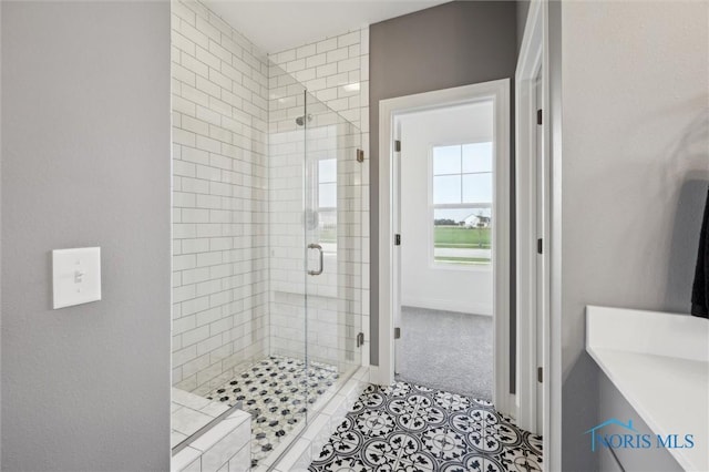 full bathroom with baseboards and a shower stall