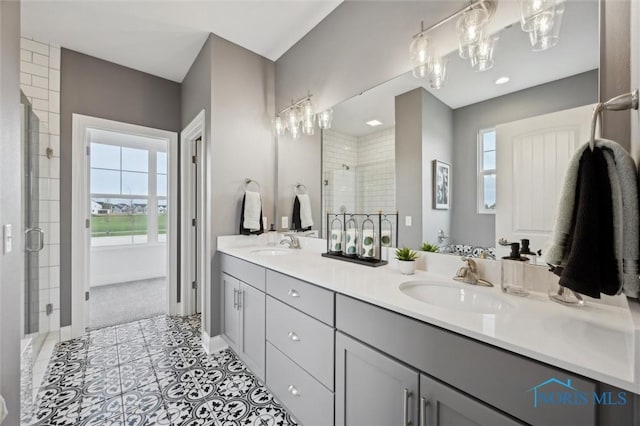 full bath with a sink, a wealth of natural light, and a shower stall