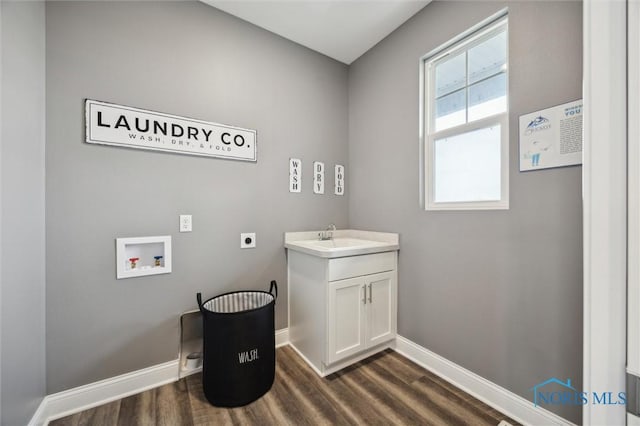 bathroom with vanity, baseboards, and wood finished floors