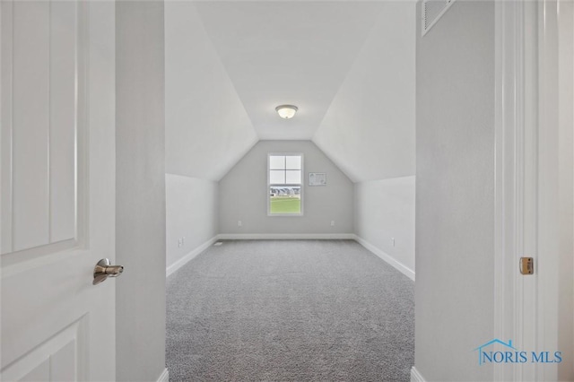 bonus room with baseboards, carpet, and lofted ceiling