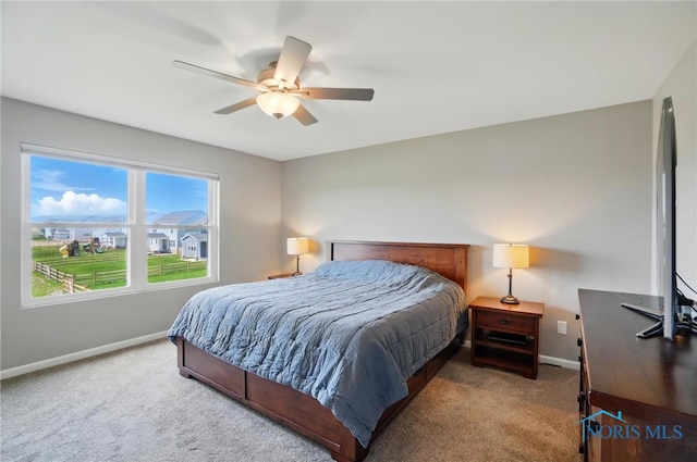 bedroom with baseboards, ceiling fan, and carpet flooring