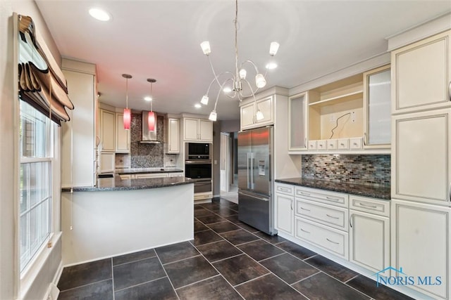 5258 Coldstream Rd, Toledo, OH 43623 - kitchen with built in appliances, wall chimney exhaust hood, cream cabinetry, open shelves, and decorative backsplash