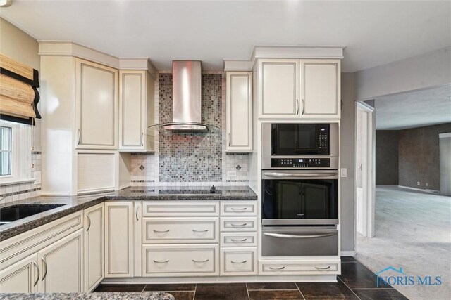 5258 Coldstream Rd, Toledo, OH 43623 - kitchen featuring black appliances, a warming drawer, wall chimney exhaust hood, cream cabinets, and tasteful backsplash