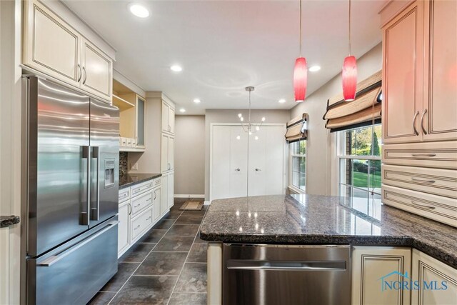 5258 Coldstream Rd, Toledo, OH 43623 - kitchen with appliances with stainless steel finishes, decorative light fixtures, a peninsula, dark tile patterned flooring, and recessed lighting