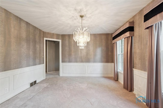 5258 Coldstream Rd, Toledo, OH 43623 - unfurnished dining area featuring a chandelier, wainscoting, carpet floors, and wallpapered walls