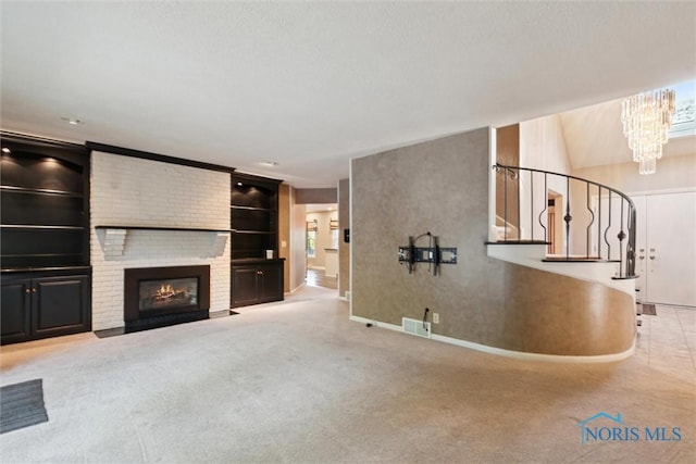 5258 Coldstream Rd, Toledo, OH 43623 - unfurnished living room with baseboards, a chandelier, stairway, a brick fireplace, and built in features
