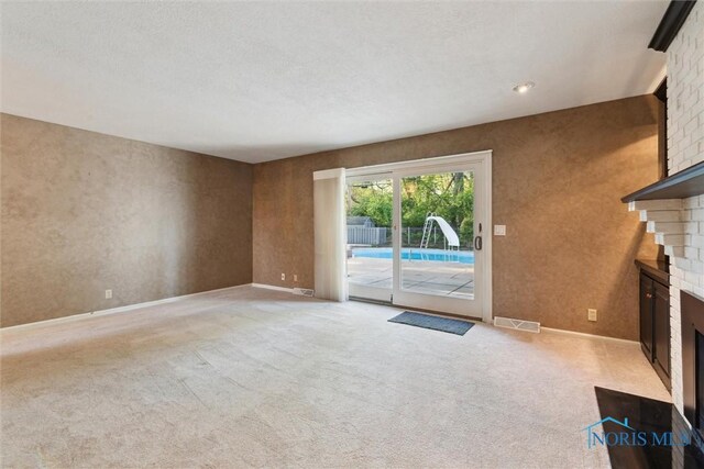 5258 Coldstream Rd, Toledo, OH 43623 - unfurnished living room featuring a brick fireplace, light carpet, and baseboards