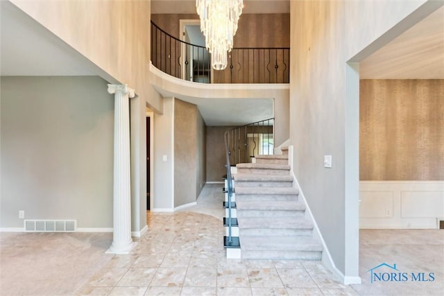 5258 Coldstream Rd, Toledo, OH 43623 - stairway featuring a chandelier, a high ceiling, and carpet floors