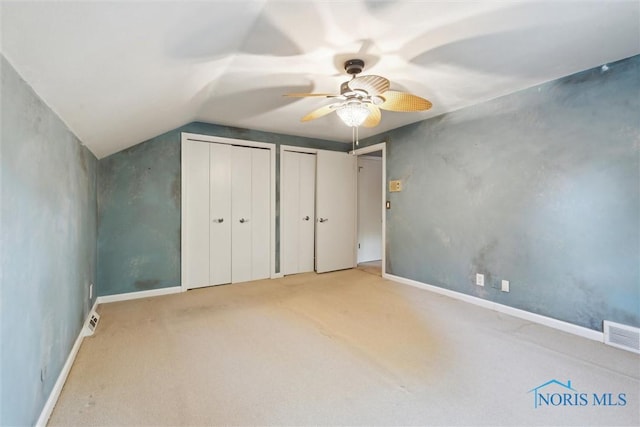 5258 Coldstream Rd, Toledo, OH 43623 - unfurnished bedroom featuring two closets, vaulted ceiling, carpet flooring, baseboards, and a ceiling fan