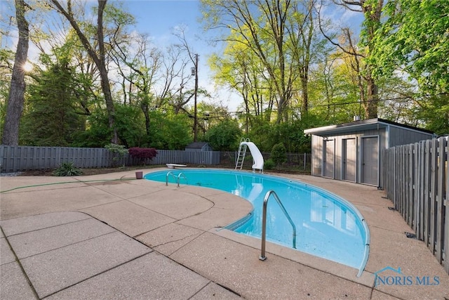 5258 Coldstream Rd, Toledo, OH 43623 - view of pool with a water slide, a fenced backyard, a patio area, and an outdoor structure