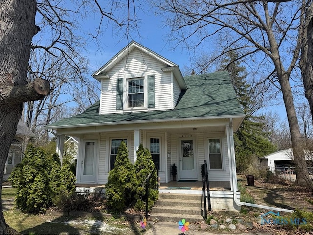 view of front of house featuring covered porch and a shingled roof