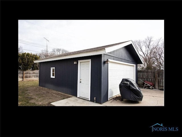 view of outbuilding with fence and an outdoor structure