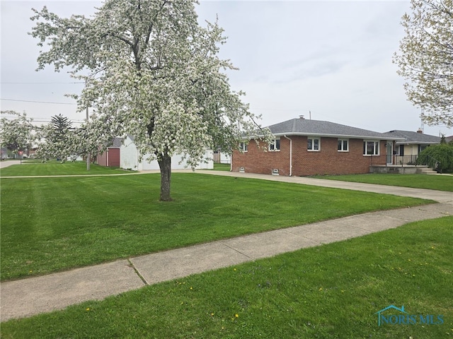 view of home's exterior featuring a lawn and brick siding