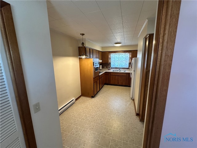 716 N Union St Unit B, Fostoria, OH 44830 - kitchen featuring decorative light fixtures, baseboard heating, light countertops, freestanding refrigerator, and stainless steel oven