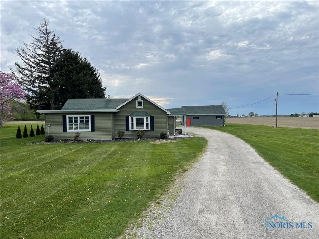 single story home with driveway and a front yard