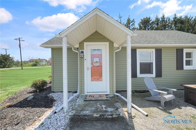 26237 Luckey Rd, Walbridge, OH 43465 - property entrance with a yard and roof with shingles