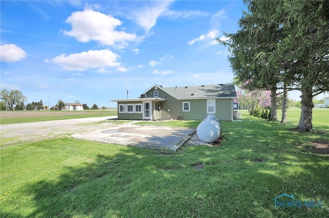 26237 Luckey Rd, Walbridge, OH 43465 - rear view of property featuring a lawn