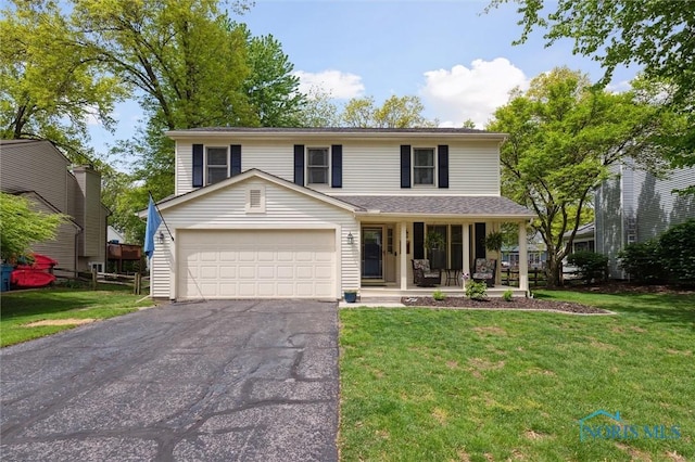 3663 Woodspring Rd, Sylvania, OH 43560 - view of front of home with a porch, driveway, a garage, and a front lawn