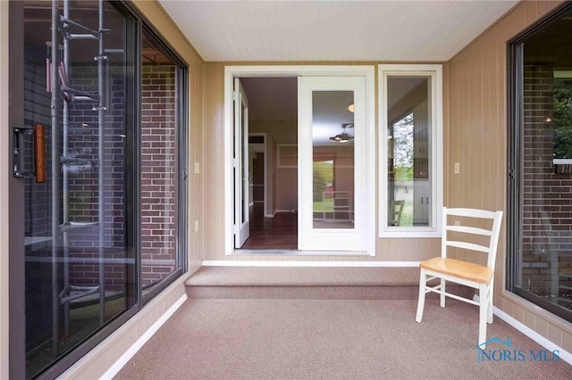 property entrance featuring brick siding